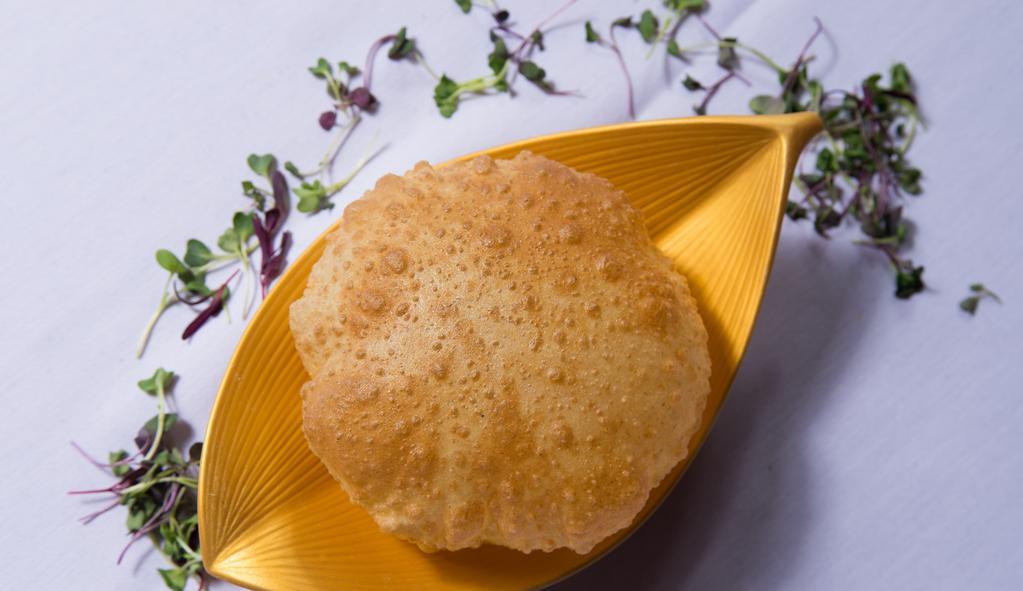 Poori · Traditional fried puffy bread.