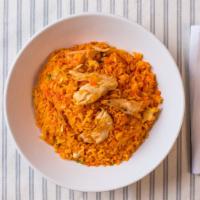 Arroz Con Pollo · Rice and chicken with salad and French fries.