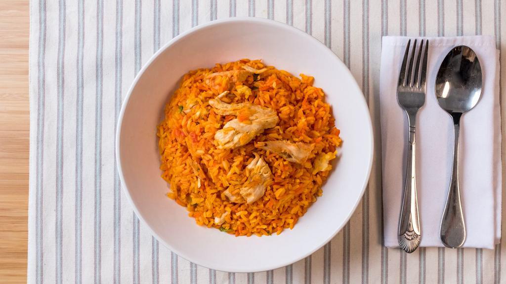 Arroz Con Pollo · Rice and chicken with salad and French fries.