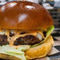 El Pobre Burger · 100% black Angus beef, cheese, lettuce, tomato, pink sauce