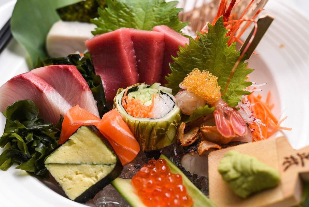 Chirashi Deluxe · Assorted exotic raw fish on the bed of seasoned rice. Served with miso soup, salad, and rice.