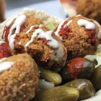 Moshe'S Falafel Signature · Our Signature Falafel Sandwich is a Freshly Baked Pita Bread filled with Crispy Traditional ...