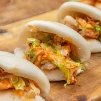 Shrimp Bao Buns · Steamed, Pillowy Bao Buns Stuffed With Grilled Shrimp, Lettuce, Crispy Onions + Sriracha May...