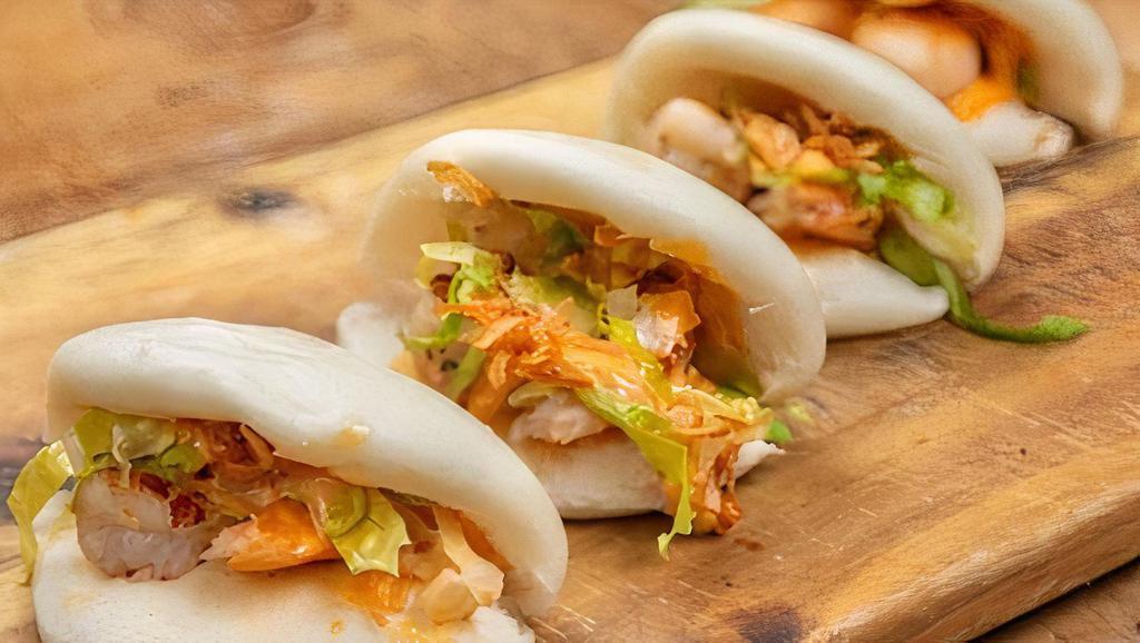 Shrimp Bao Buns · Steamed, Pillowy Bao Buns Stuffed With Grilled Shrimp, Lettuce, Crispy Onions + Sriracha Mayo (4 Pieces).