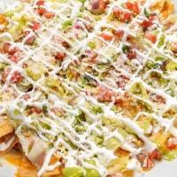 Nachos · Tortilla Chips, Melted White Cheddar Cheese, Pinto Beans, Lettuce, Pico De Gallo, Green Chil...