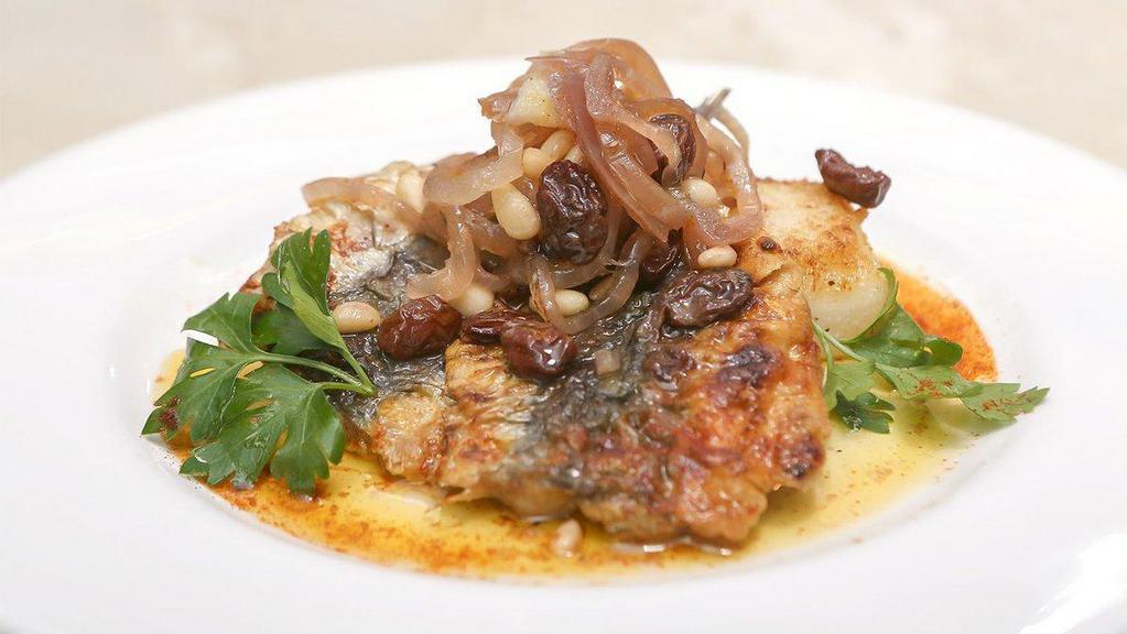 Sardines · Marinated in vinegar, onion, raisins and pine nuts over baked polenta.
