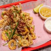 Fried Calamari · Fried calamari tossed in mojo de ajo. (garlic oil & seasoning)