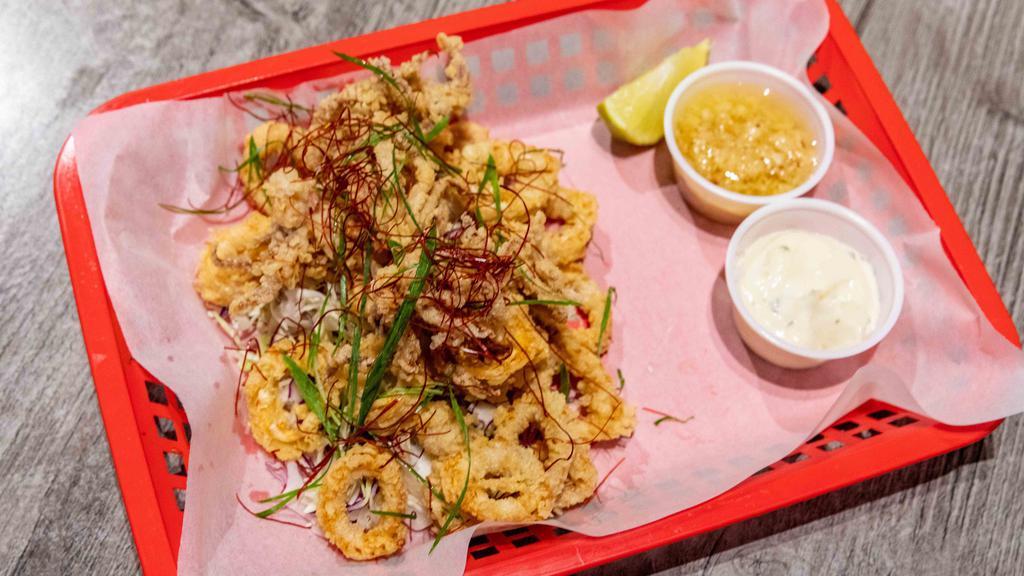 Fried Calamari · Fried calamari tossed in mojo de ajo. (garlic oil & seasoning)