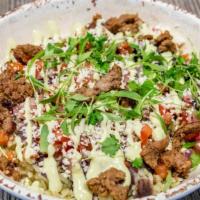 Burrito Bowl · Cilantro Rice topped with choice of meat, corn relish, black beans, & avocado crema.