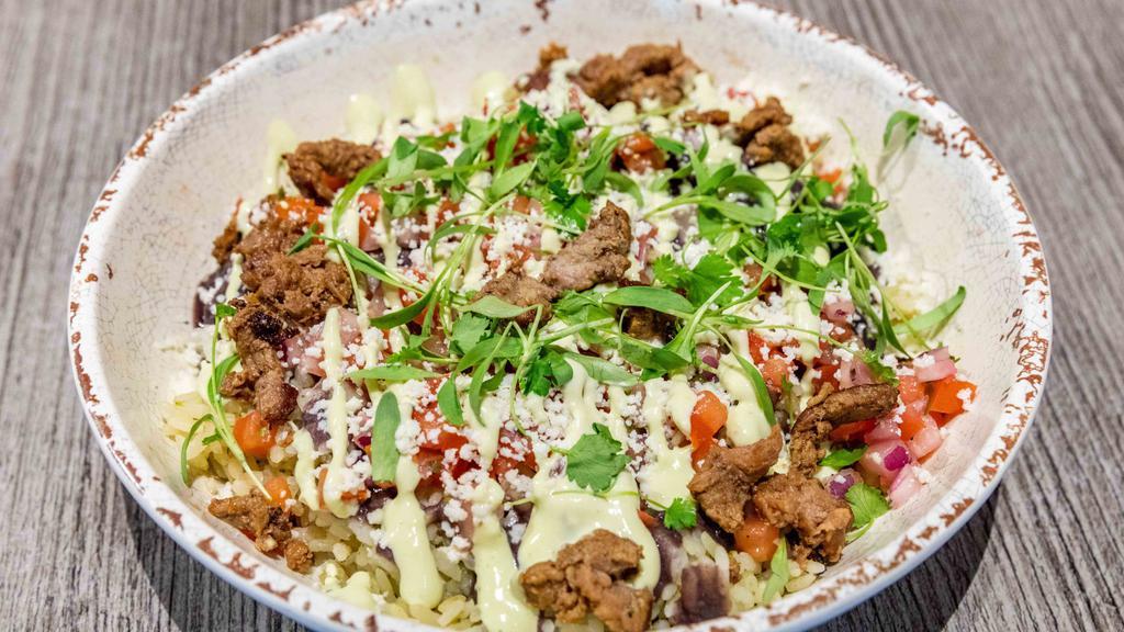 Burrito Bowl · Cilantro Rice topped with choice of meat, corn relish, black beans, & avocado crema.