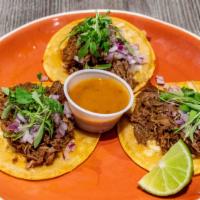 Birria Beef Tacos · 3 Birria Beef Tacos topped with chihuahua cheese, cilantro, onions, salsa roja, and lime