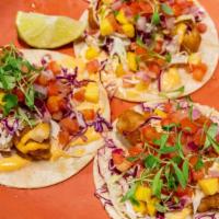 Local Catch Fish Tacos · Our famous baja-style tacos topped with fried fresh local catch, kuhio cabbage slaw, mango s...