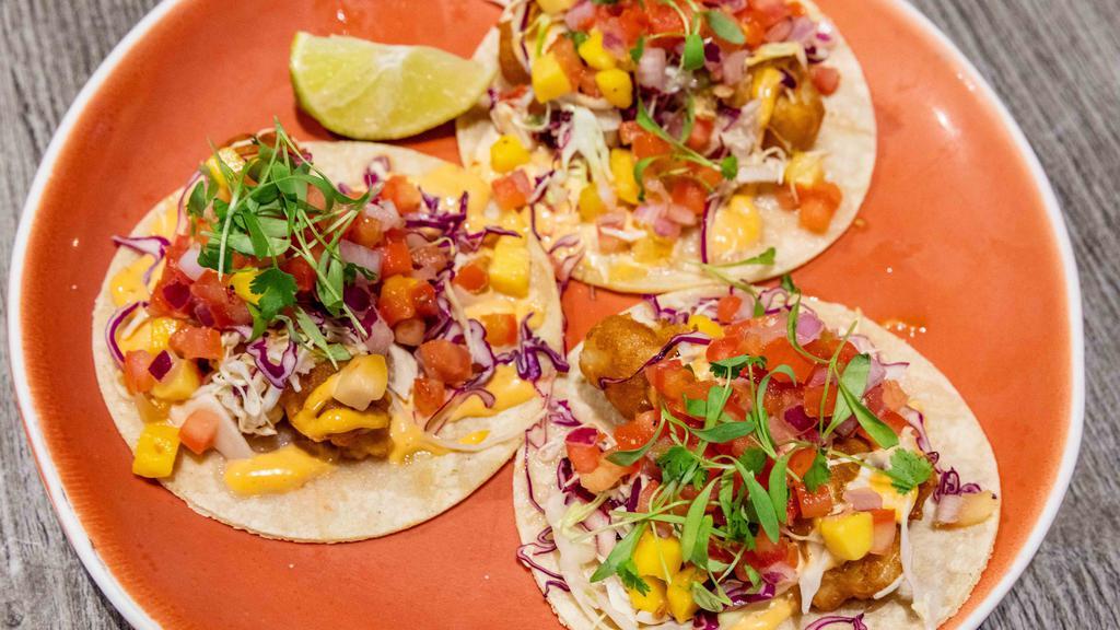 Local Catch Fish Tacos · Our famous baja-style tacos topped with fried fresh local catch, kuhio cabbage slaw, mango salsa, chipotle mayo, and lime.  Customer favorite!