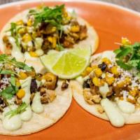 Pollo Asado Tacos · 3 street tacos topped with pollo asado, corn relish, avocado crema, and lime