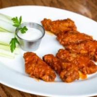 Chicken Wings · Cage-free chicken wings served in your choice of buffalo or barbeque sauce. Served with cele...
