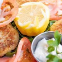 Homemade Crab Cakes · Three pieces of pan-seared Homemade Crab Cakes served with aioli sauce.