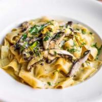 Pappardelle Portobello · Portobello mushrooms over pappardelle pasta with creamy sauce and topped with fresh parsley.