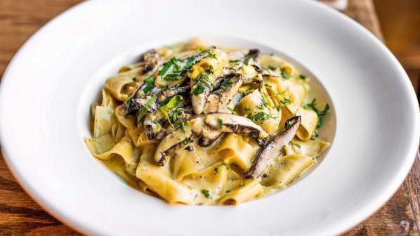 Pappardelle Portobello · Portobello mushrooms over pappardelle pasta with creamy sauce and topped with fresh parsley.