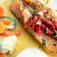 Salmon Scaloppini · Pan seared salmon cooked in garlic wine sauce and sun dried tomatoes. Served with mashed pot...