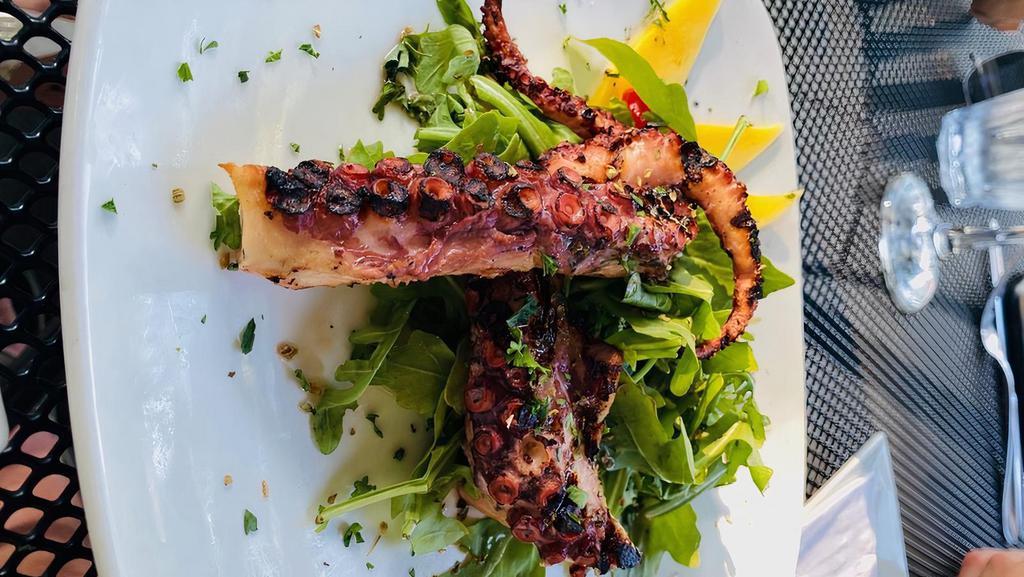 Grilled Octopus · Grilled Mediterranean octopus, arugula, EVOO, grape tomatoes and mango.