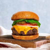 Cheese Kiss Burger · Sirloin patty topped with melted cheese, lettuce, tomato, onion, and pickles. Served on a wa...