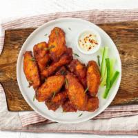 Cluck Chuck Wings · Fresh chicken wings breaded and fried until golden brown. Served with a side of ranch or ble...