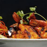 Tandoori Shrimp · Plump shrimp marinated with our house masala spice blend and grilled in our clay ovens until...