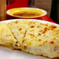 Paneer Naan · Fresh, puffy flatbread filled with our house-made yogurt cheese and freshly baked to order.