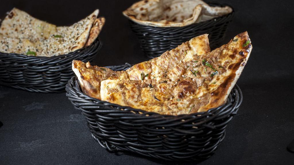 Keema Naan · Fresh, puffy flatbread filled with ground lamb, herbs and spices and freshly baked to order.