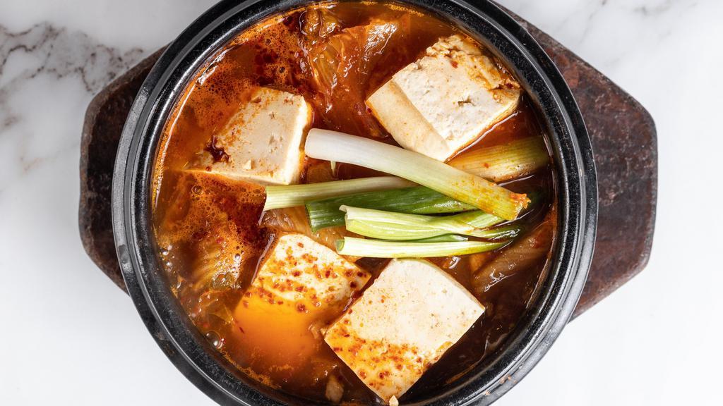 김치 찌개 / Kimchi Jigae · Spicy stew made with ripened kim chi, pork, and tofu.