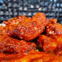 Buffalo Wings · Crispy buffalo wings nine served mild or spicy, paired with Bleu cheese dressing.