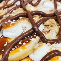 Nutella Pancakes · Our classic pancakes drizzled with nutella hazelnut spread and powdered sugar.