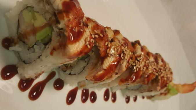 Black Dragon Roll · Inside spicy shrimp, crab stick and mango, outside eel, avocado and eel sauce and masago.