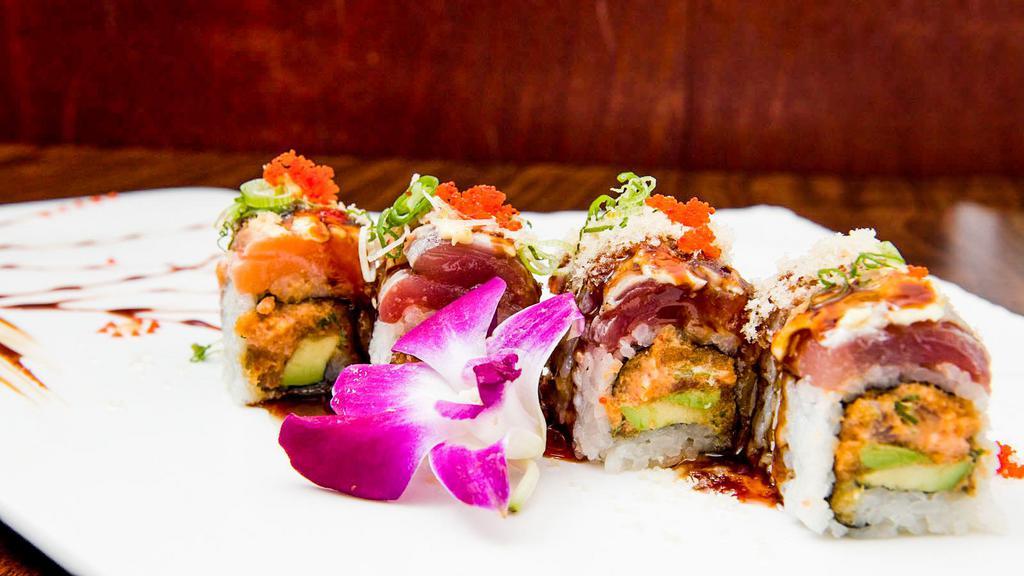 Godzilla Roll · Spicy tuna, spicy yellowtail, avocado inside, topped with tuna, salmon seared with special sauce.