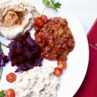 Middle Eastern Salad Platter · Assortment of hummus, tahini, Baba Ganoush, red cabbage slaw, roasted beets. Served with 2 p...