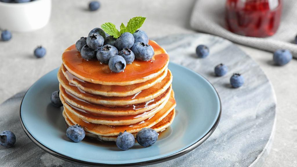 Blueberry Pancakes · Delicious, hot buttermilk pancakes cooked to perfection. Topped with fresh blueberries.