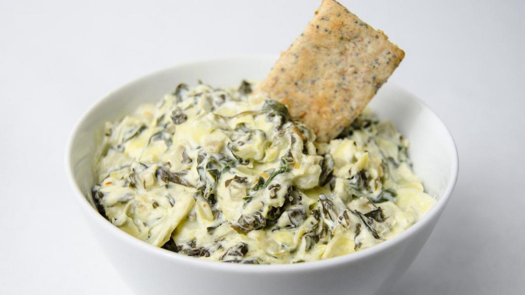 Artichoke Dip · Spinach, Parmesan, and feta dip, served with spiced pita chips.