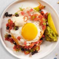 Huevos Rancheros · Lightly fried eggs served on a warm tortilla and topped with salsa, tomatoes, chili peppers,...