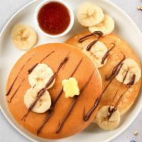 Banana Nutella Pancakes · Fluffy banana nutella pancakes cooked with care and love served with butter and maple syrup....