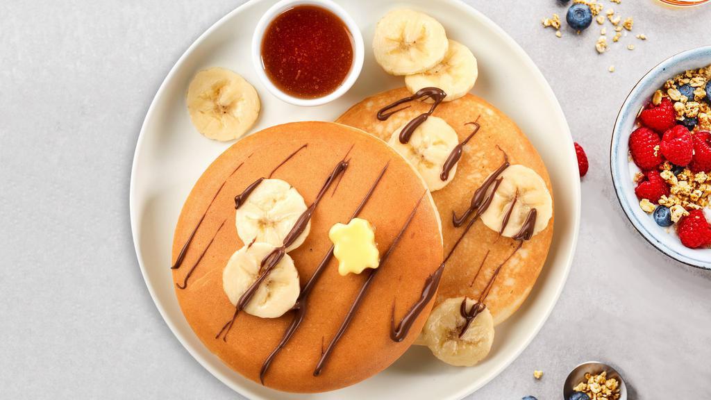 Banana Nutella Pancakes · Fluffy banana nutella pancakes cooked with care and love served with butter and maple syrup. Served in pairs.