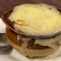 French Onion Soup With Swiss Cheese · Medley of onions simmered in a traditional broth accented with. sherry wine, topped with a h...