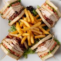 Turkey Club Sandwich · Roast turkey with bacon, lettuce, tomato, and mayonnaise.. Served with French fries.