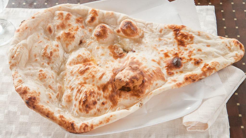 Garlic Naan · Leavened bread of super fine flour baked in tandoor and topped with garlic.