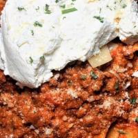 Pasta Bolognese · Fresh ground beef with tomato sauce and a touch of heavy cream, topped with Ricotta cheese.