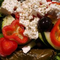 Greek Salad · Romaine lettuce, tomato, onion, cucumber, feta cheese, olives, stuffed grape leaf, oregano a...