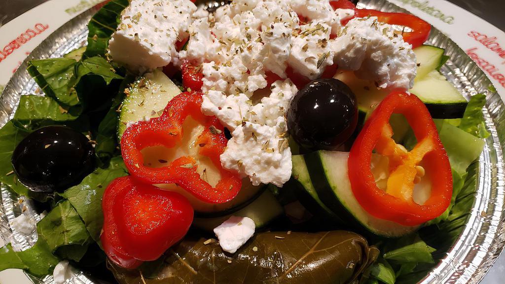 Greek Salad · Romaine lettuce, tomato, onion, cucumber, feta cheese, olives, stuffed grape leaf, oregano and dressing.