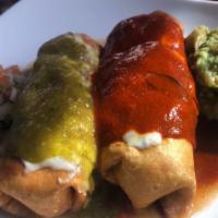 Chimichanga · 2 deep fried flour tortillas filled with choice of chicken or ground beef. Topped with melte...