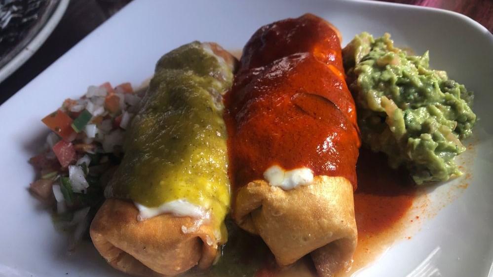 Chimichanga · 2 deep fried flour tortillas filled with choice of chicken or ground beef. Topped with melted cheese, green, and red salsa. Served with pico de gallo, guacamole, rice, and beans.