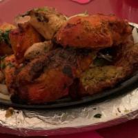 Mixed Grill Appetizer · A mixed sampler platter of tandoori chicken, chicken tikka, Kashmiri kebab, and chicken seek...