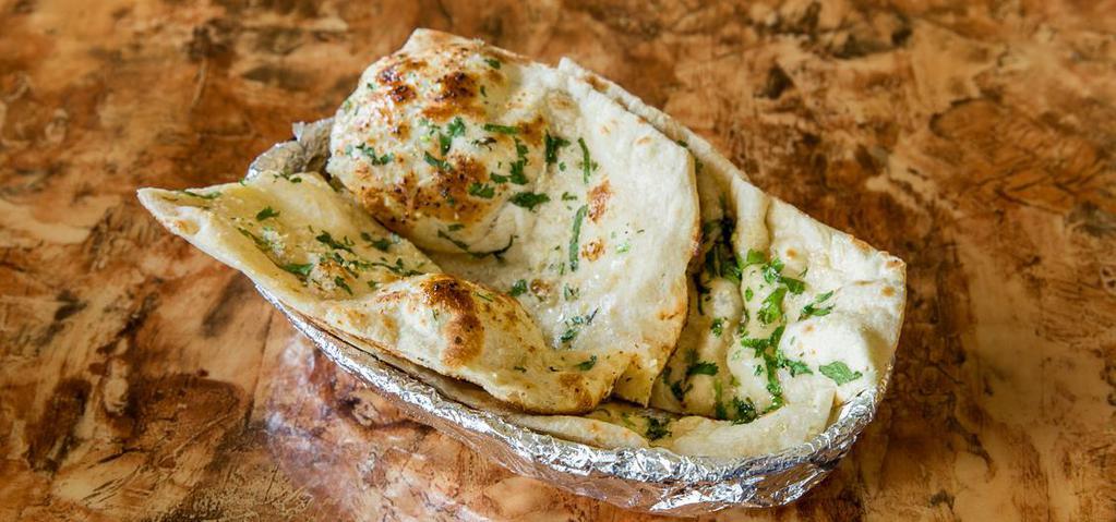 Garlic Naan · White flour bread topped with fresh chopped garlic.